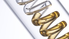 Getting natural oil from natural substances and flowers. Yellow oil flows in a spiral. Super slow motion filmed on high speed cinematic camera. - Powered by Shutterstock - Get 15% off with code: PIKWIZARD15
