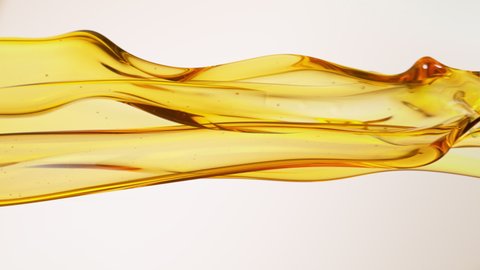 Super Slow Motion Shot of Flowing Oil on White Background at 1000fps.