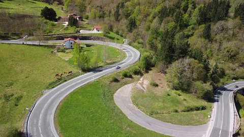 Cars driving along the mountain road of the ascent to the Puerto del Escudo, in Cantabria. 