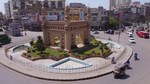 Static drone shot of a monument roundabout in Karachi as Traffic circulates it. Karachi, Pakistan. 25th March 2021