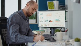 Company accountant taking notes on statistics papers to create financial analysis in office. Startup employee working on research strategy with data documents for business growth. - Powered by Shutterstock - Get 15% off with code: PIKWIZARD15