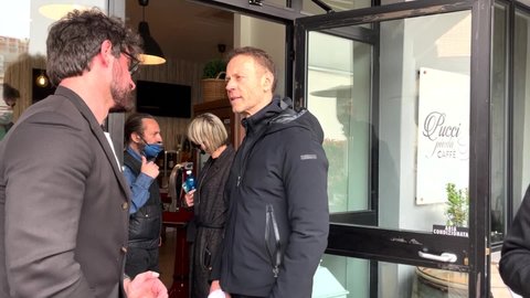 MILANO, ITALY - APRIL 22, 2022: On the right side, the legendary italian porn actor Rocco Siffredi with a fan. 