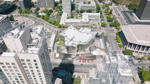 LOS ANGELES, CALIFORNIA, USA April 2023. Beautiful overhead aerial of the Walt Disney Concert Hall in downtown Los Angeles, Dorothy Chandler hall is visible on side, sunny summer day in city 
