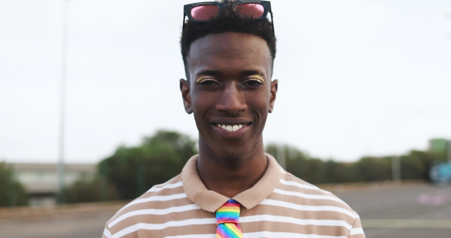 Happy gay african man with make-up smiling on camera outdoor Royalty-Free Stock Footage #1089608245