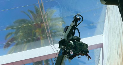 LOS ANGELES, CALIFORNIA, USA - MARCH 26, 2022: Media broadcast crew prepares TV camera crane equipment for the Red Carpet Oscar academy award nomination coverage in Los Angeles, California, 4K
