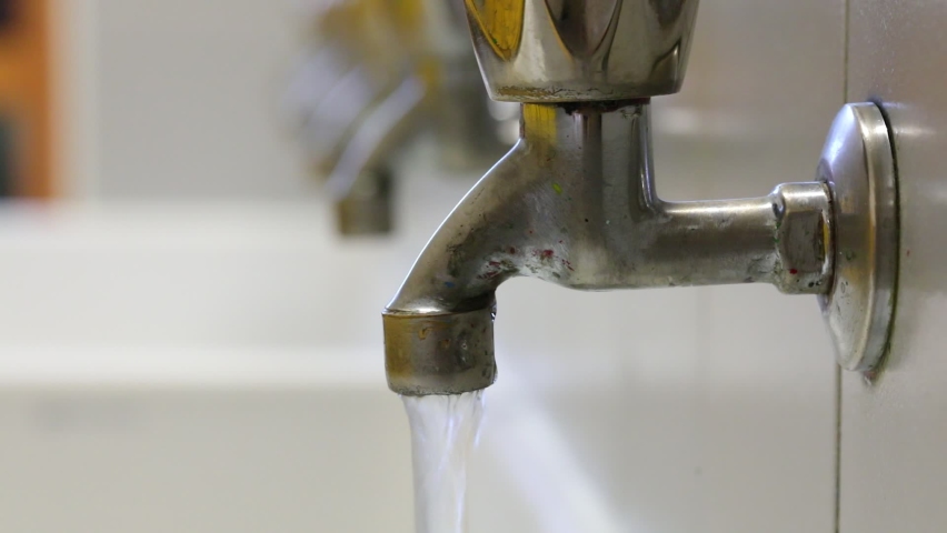 Hand of man closing the water tap in the sink to avoid waste | Shutterstock HD Video #1089613761