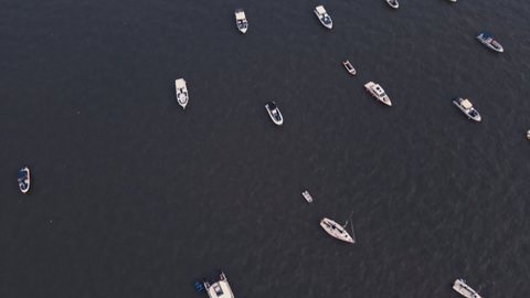 Aerial view of South Mumbai. Early morning view from Gateway of India. Drone shot of fishing boats sailing in the Arabian Sea. Sunrise light falling on the seawater at Gateway of India, Mumbai