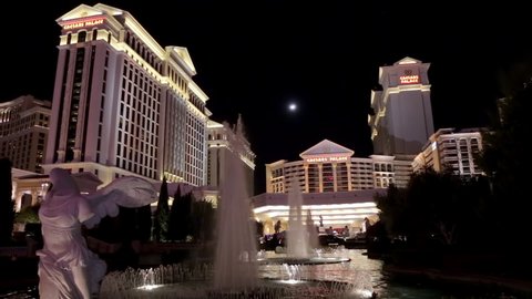 Las Vegas, USA - January 2016 : Caesars Palace luxury hotel and casino entrance at night and fountains in Paradise, Nevada, United States