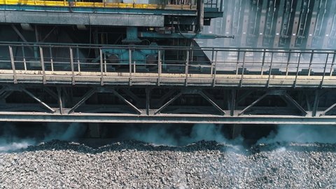 The production process of coke oven coal. Hot coke coal at the plant. Coke coal is poured from a railway car for cooling