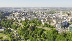 Inscription on video. Luxembourg, Historical city center in the morning. Pont Rouge. Appears from the sand, Aerial View, Departure of the camera