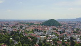 Inscription on video. Graz, Austria. The historic city center aerial view. Mount Schlossberg (Castle Hill). On the mechanical display, Aerial View