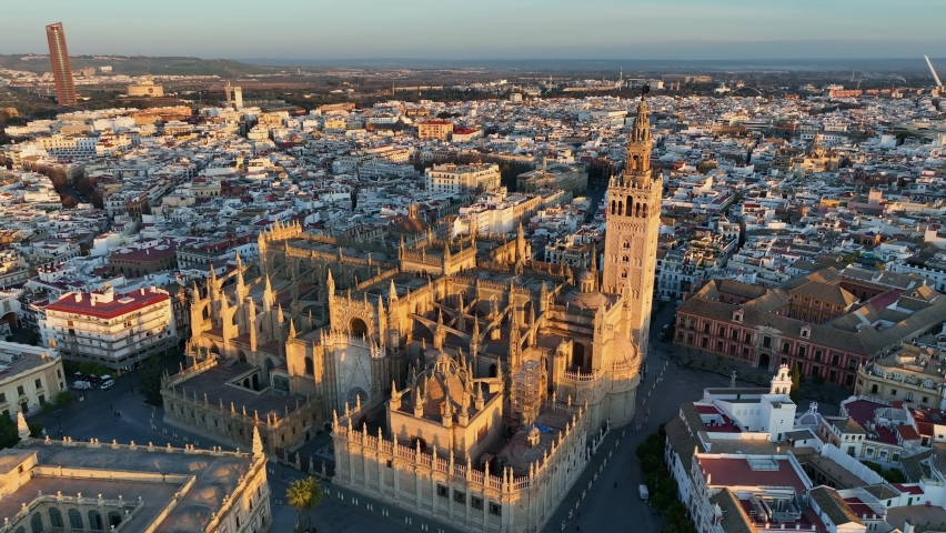 Gorgeous sunrise in Seville, Spain. Aerial shot of Seville city center with gothic cathedral and famous Giralda bell tower. Royalty-Free Stock Footage #1089617933