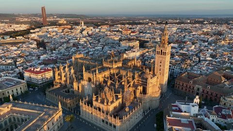 Gorgeous sunrise in Seville, Spain. Aerial shot of Seville city center with gothic cathedral and famous Giralda bell tower.
