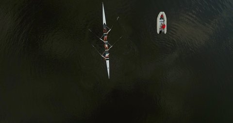 Aerial view of a sports canoe driven by a team of Ukrainian young men in river water. rowing team of four is getting ready for a rowing competition rowing boat.