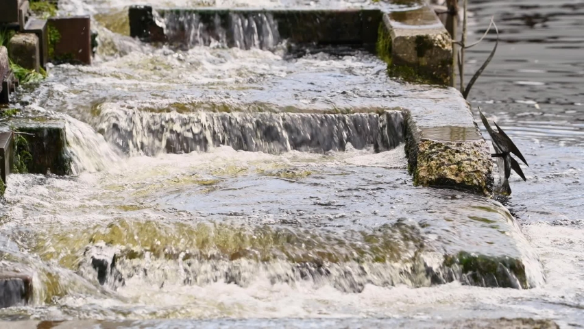 Footage with sound of water games of a water staircase for fish in a spa lake in Grafenau in the Bavarian Forest, Germany