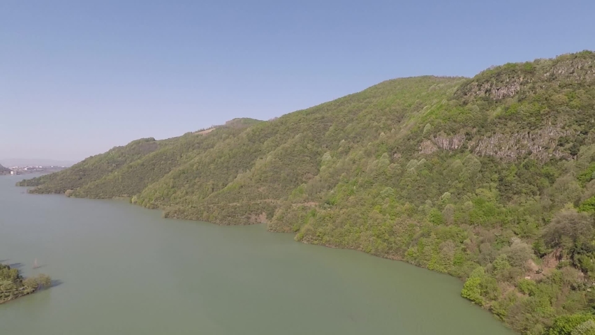 green mountains and lake, aerial shot pan green mountains and lake, srpring