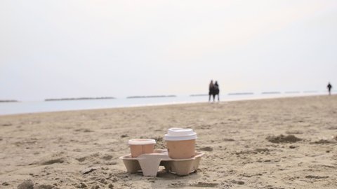 Coffee to go. Coffee break in an open space. Morning coffee on the seashore by the coastline. Peace and tranquility as a time for yourself. High quality 4k footage