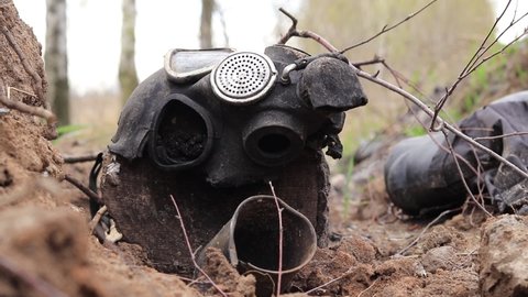 Ukraine, Yasnohorodka, Kyiv Oblast - 04.26.2022: Broken gas mask of the Russian army on the ground. Consequences of Russia's military attack on Ukraine.