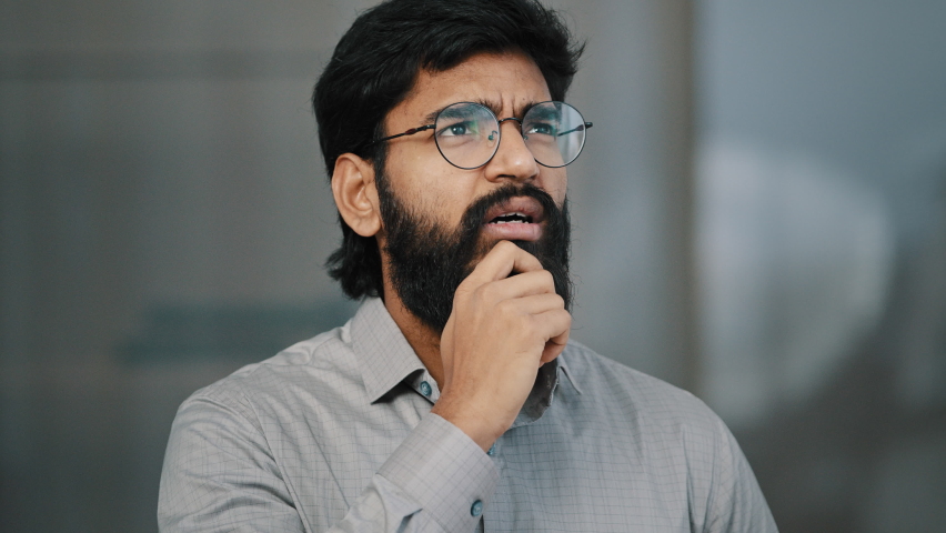 Close-up portrait arabian male pensive business man hold hand on chin concentrated think of solution issue deep in thoughts excited young eyeglasses guy raise finger come up with good idea find answer Royalty-Free Stock Footage #1089624945