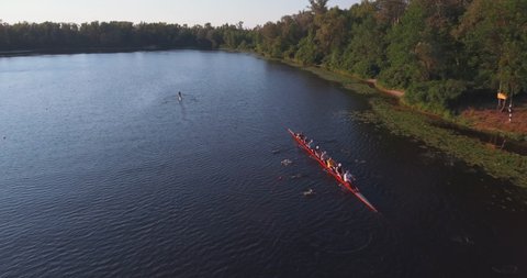 Aerial view of eight rowing athletes rowing a boat on the river. sport leisure hobby rowing healthy lifestyle outdoors. Rowers are trained on the Dnieper River in the city of Kyiv, Ukraine.