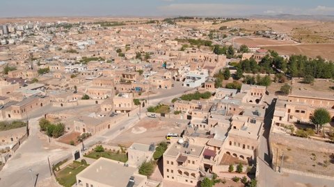 Aerial view of Midyat city, Mardin province, Turkey. Flying over historic part of Midyat at sunny day, Eastern Anatolia, Turkey. Drone footage of the Midyat old town
