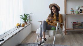 Knitting and needlework, a woman knits with knitting needles sitting in a chair, knitted products from a woolen thread, hobby and leisure at home - Powered by Shutterstock - Get 15% off with code: PIKWIZARD15