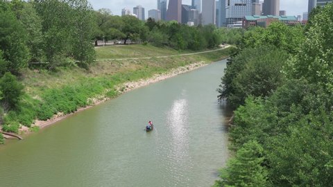 Houston, TX, US - April 23, 2022:  Couple in canoe paddle down Buffalo Bayou in Houston Texas.