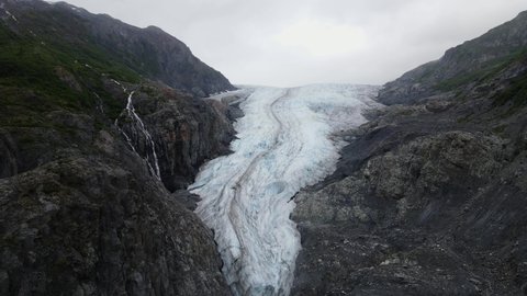 Aerial view over a shrinking glacier - global warming and climate change in progress