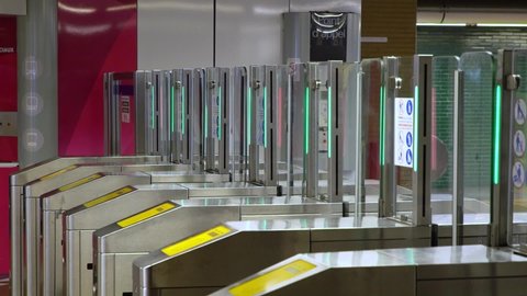 Marseille, France - April 28, 2019: The girl applies a card to the terminal for passage in the subway. Metro turnstiles. 