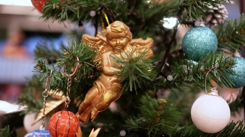 Angel kid decoration at the Christmas tree with blinking led lighting