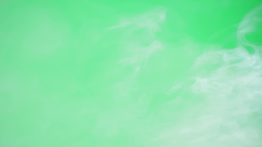 Abstract smoke on green chroma key background. Smoking, steam clouds close-up. Royalty-Free Stock Footage #1089640883