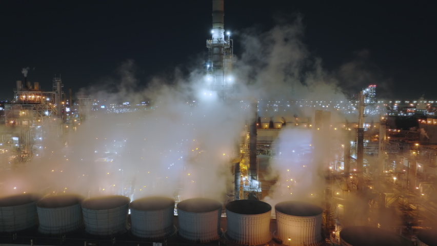 Commercial factories within big site as seen at night from above. Aerial view of the industrial business area, operating around the clock. High quality 4k footage Royalty-Free Stock Footage #1089641415