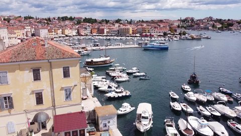 Rovinj , Croatia - 08 28 2021: Rovinj Harbor in Istria, Croatia - Aerial of Boulevard, Restaurants and Boats