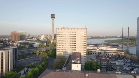 Rhine Tower and Rheinkniebrucke Bridge, iconic buildings in Dusseldorf, international business and financial centre. Germany cityscape - aerial crane shot
