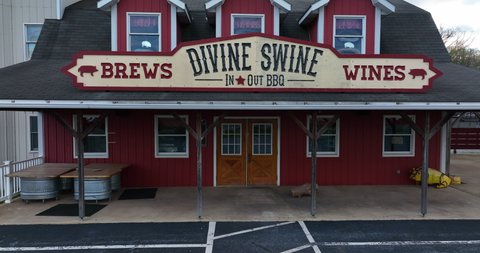 Manheim , PA , United States - 04 10 2022: Divine Swine restaurant. Rising exterior aerial shot. Old fashioned brews and wines at BBQ joint.