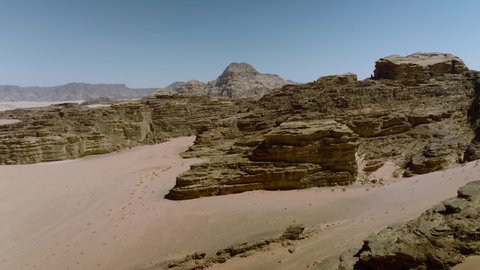 Fly Over Rock Formations On The Arid Desert Of Wadi Rum In Jordan. Aerial Drone Shot
