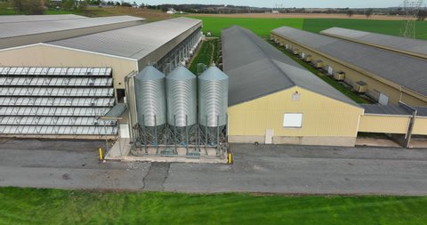 Chicken house egg laying hens and broilers. Factory farm in USA deals with Avian Flu. Aerial establishing shot.