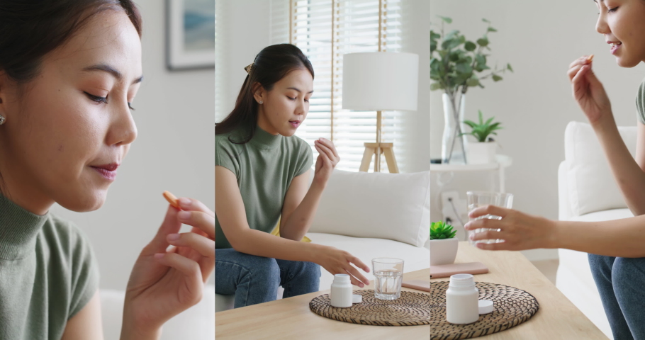 Asia people young woman happy relax smile sit at home sofa drink water take birth control pill pouring folic preconception drug bottle or weight loss diet capsule. Body skin health care sick relief.