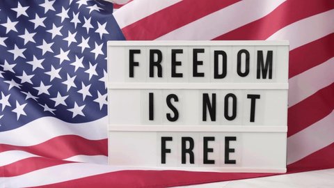 4k Waving American Flag Background. Lightbox with text FREEDOM IS NOT FREE Flag of the united states of America. July 4th Independence Day. USA patriotism national holiday. Usa proud.