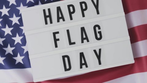 Slow motion Waving American Flag Background. Lightbox with text HAPPY FLAG DAY Flag of the united states of America. July 4th Independence Day. USA patriotism national holiday. Usa proud.