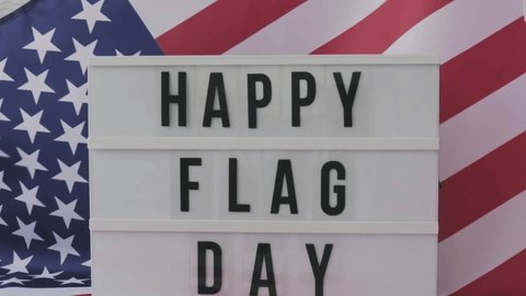 Slow motion Waving American Flag Background. Lightbox with text HAPPY FLAG DAY Flag of the united states of America. July 4th Independence Day. USA patriotism national holiday. Usa proud.