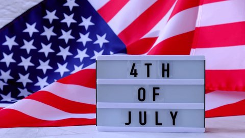 4k Waving American Flag Background. Lightbox with text 4TH OF JULY Flag of the united states of America. July 4th Independence Day. USA patriotism national holiday. Usa proud.