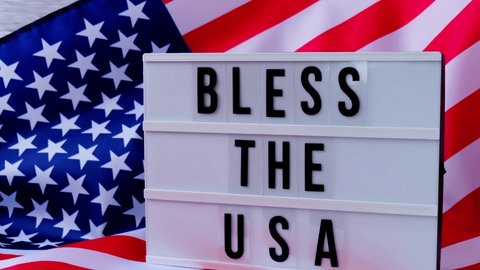 4k Waving American Flag Background. Lightbox with text BLESS THE USA Flag of the united states of America. July 4th Independence Day. USA patriotism national holiday. Usa proud.