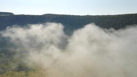 In the morning a thick fog spreads through the valley. Footage from a bird's eye view. Location place Dniester canyon, Ukraine, Europe. Cinematic drone shot. Filmed in UHD 4k video. Beauty earth.