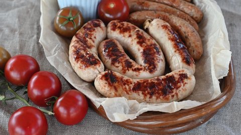 Grilled sausages with sauces and vegetables. Tasty food concept