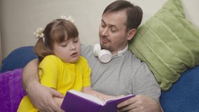 child with his father read an interesting book laugh, kid studies school homework remotely with dad, little girl laughs with daddy over fairy tale, world knowledge and miracles, dream imaginations.