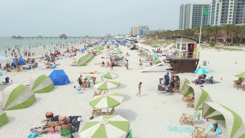 Aerial view over people at white sand beach in Clearwater, Florida during spring break