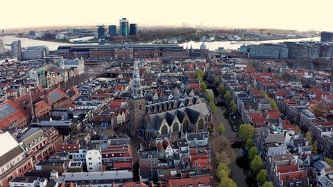 Aerial orbiting shot of Landmark The Oude Church in Amsterdam old center, Holland 4K