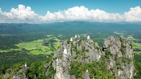 Drone flying above pagodas with panoramic view of northern thailand