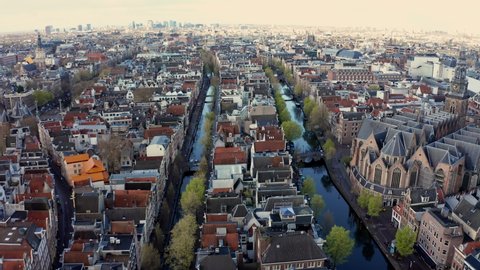 Opening drone shot of narrow canals in the center city of Amsterdam, Holland 4K